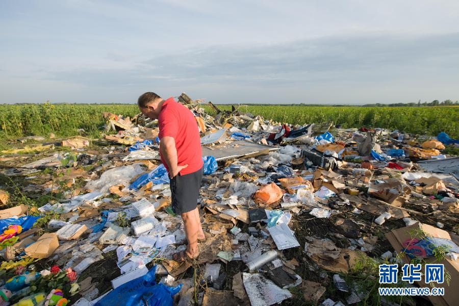 　7月19日,在烏克蘭頓涅茨克州,一名當地民眾站在馬航MH17航班墜機現場。